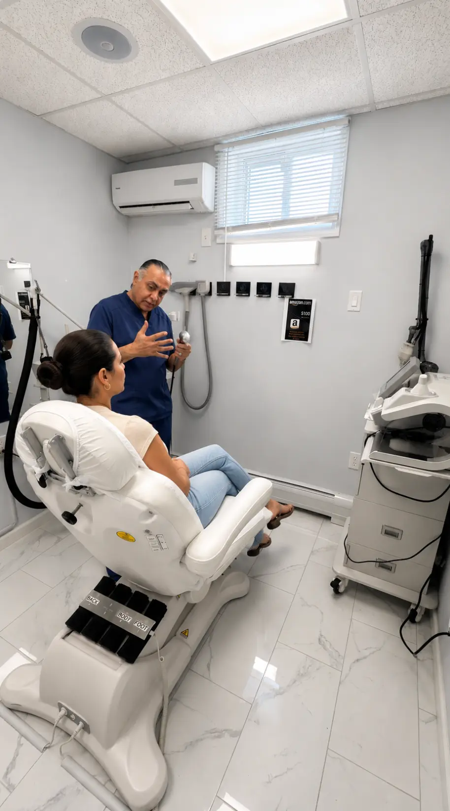 Medical provider explaining a body contouring handpiece to a seated patient in a Bergen County treatment room